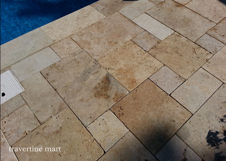 Ivory Swirl travertine paving in a real pool-edge project.